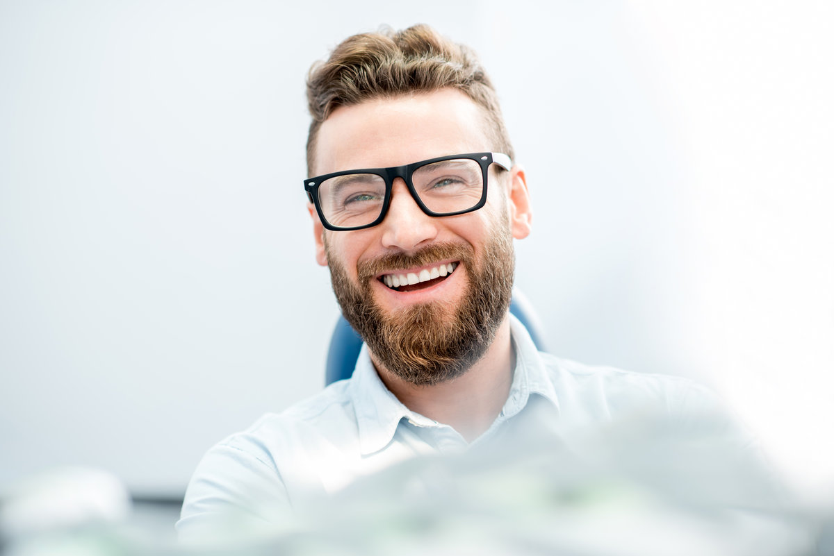Handsome businessman with great smile sitting on the dental chair